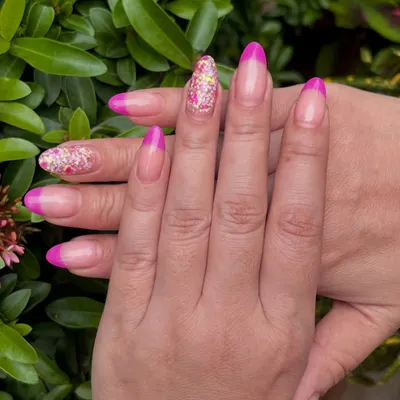 A perfect example of the versatility of dip powder. This is my French Dip manicure, featuring a vibrant pink tip and a sparkling glitter accent nail. This look is a week old and still looks absolutely fresh.