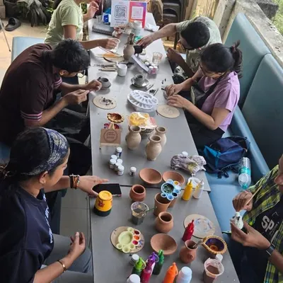 A high-angle view of a full painting workshop at my studio. You can see the variety of pots and paints available for everyone to choose from.