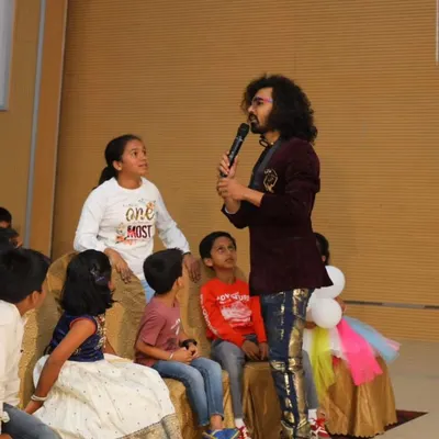 A group of kids gathered around, completely captivated by the magic. I love these intimate moments where I can perform illusions up close.