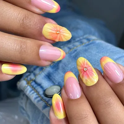 This summer-ready set features a pastel yellow French tip with a dreamy aura glow. The accent nail is adorned with a soft, hand-sculpted 3D flower on a blush pink aura base, creating a fresh and fun design.