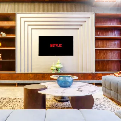 This entertainment unit is the centerpiece of the living room. I designed it with a unique geometric pattern and integrated shelving, blending rich wood with a modern aesthetic.