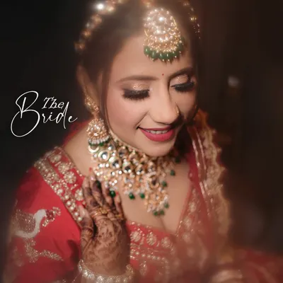 A beautiful close-up of the bride, capturing her happy smile and the intricate details of her makeup and jewelry.