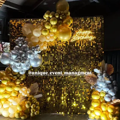 A glamorous 25th birthday party setup featuring a shimmering gold sequin wall that makes a perfect photo booth. We completed the look with a custom 'Happy Birthday' neon sign and organic balloon garlands in gold, silver, and white for a chic celebration.