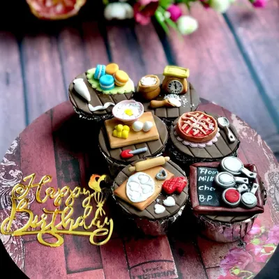 My custom cupcakes are tiny canvases for edible art. This set was designed for a fellow baker, featuring incredibly detailed, handmade fondant toppers that represent the tools of our trade, from a miniature pie and macarons to a tiny scale and rolling pin.