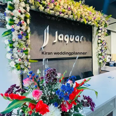 A floral frame and bouquet arrangement designed for a corporate space. This shows how I can incorporate brand logos and create an elegant atmosphere for professional events.