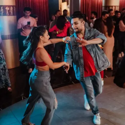 Dancing through the night at a social. We love the energy of a crowded dance floor and connecting with fellow dancers.