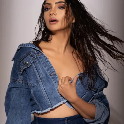 An edgy, high-fashion take on denim. The wet hair look, undone jacket, and intense expression are all part of the creative direction to create a raw and powerful image.