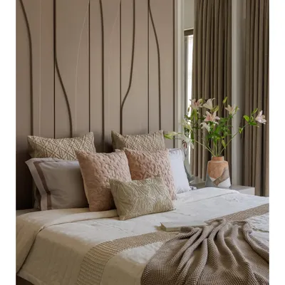 This bedroom from our Santacruz apartment is designed to feel like a gentle exhale. The tone-on-tone palette of warm taupes and blush accents, combined with a full-height textured headboard, creates a space that is calm, grounded, and quietly luxurious.