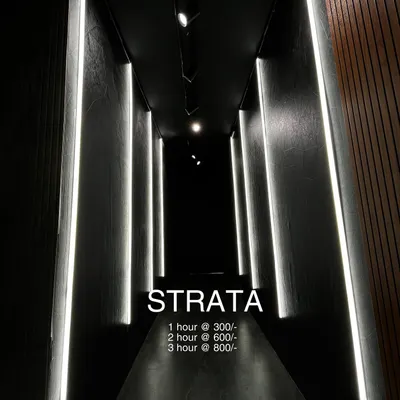 This is the 'Strata' booth. A dark, narrow hallway lined with vertical white light panels that create a futuristic, high-contrast look. It's a unique, ready-made set for your next music video or dance reel, with rental rates listed.