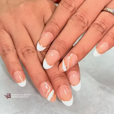 Proving that simple can be stunning. This is my take on the "clean girl" aesthetic, featuring a classic French manicure on almond nails with a delicate swirl of rose gold glitter for a subtle pop.