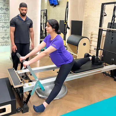 Eight months pregnant and feeling amazing. Our instructor guides this mama to be through a modified lunge on the Reformer, focusing on stability and pelvic floor health.