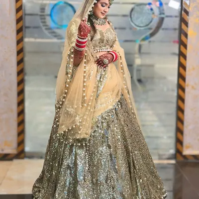 This full-length shot showcases the incredible sparkle of my gold and silver sequin lehenga. The way it catches the light is just breathtaking, making it a perfect choice for a sangeet or reception night.