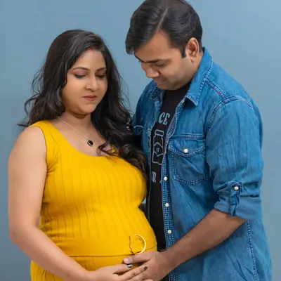 In the studio, we can create these quiet, intimate portraits. Here, the focus is purely on the connection between the couple and their shared excitement as they look down at the baby bump together.