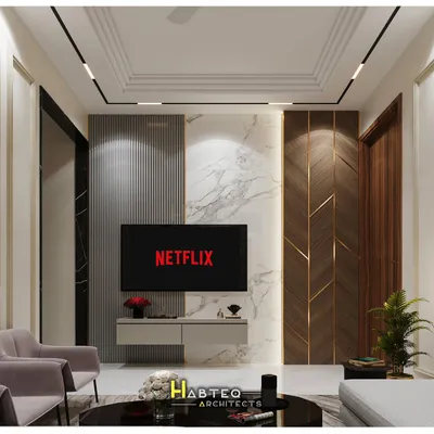 A 3D render of a TV unit wall, combining vertical WPC louvers, white marble, and wood paneling with brass inlays. This design for a 2BHK flat shows how to create a sophisticated entertainment zone.