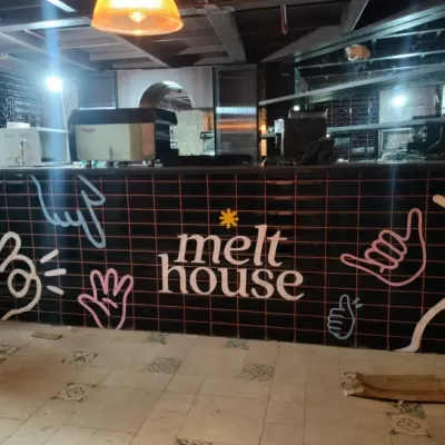 The finished counter at Melt House in Gurgaon, featuring our custom neon-style doodle art. This design adds a cool, modern vibe to the cafe's ordering area, making it instantly inviting.