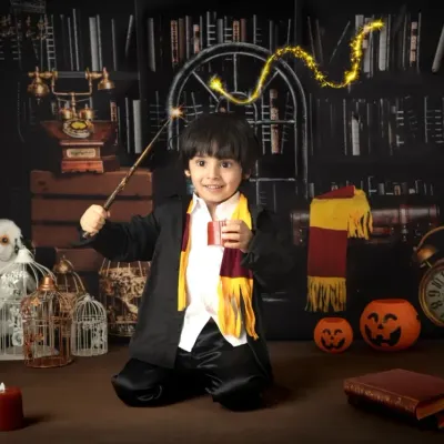 A young wizard casts a spell with a magical light trail effect. My themed sessions include creative editing to add an extra layer of fantasy.