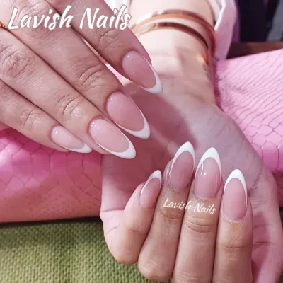A timeless classic, these long, almond-shaped nails feature a clean and elegant French manicure with crisp white tips on a natural pink base. This look is perfect for a sophisticated, everyday style.