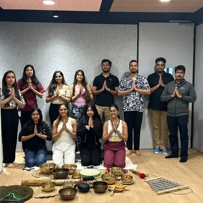 A group photo with employees after a corporate wellness session focused on sound healing and meditation. It's rewarding to bring these calming practices into a busy office environment.
