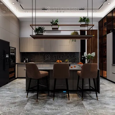 This kitchen in Alameda, Gurgaon, is designed for a seamless cooking and social experience. The large central island provides ample workspace and seating, while the sleek, handle-less cabinets and integrated appliances maintain a clean, modern aesthetic.
