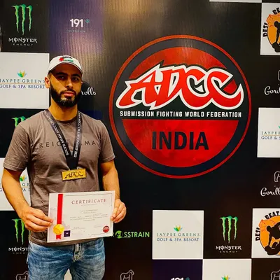 Zaid holding his certificate and gold medal at the ADCC India Open. This was his first-ever tournament, and he set a high standard for what's to come.