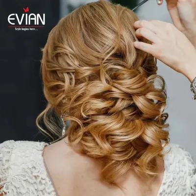 This intricate bridal updo is one of our specialties. We style the hair with soft curls and twists to create a romantic look that is both beautiful and secure for a long day of festivities.