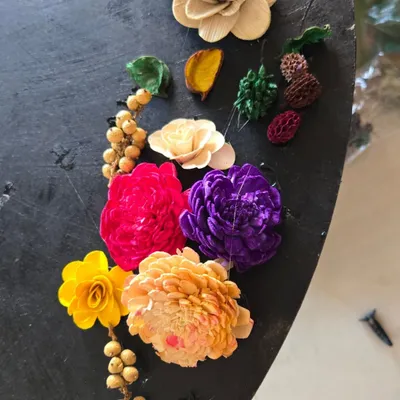 A beautiful arrangement of sola wood flowers and dried botanicals, showcasing some of the craft materials we use. Our workshops are a hands-on experience with a diverse range of art supplies.