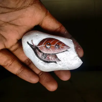 A tiny painting of a leaf with water droplets on a pebble. This piece shows the level of realism I can achieve even on a very small and unconventional surface.