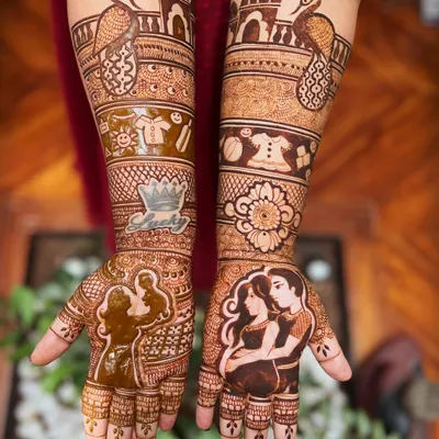 A beautiful and meaningful mehendi design for a mom-to-be. It features portraits of the expecting parents, along with cute baby clothes and a crown for their little prince or princess.