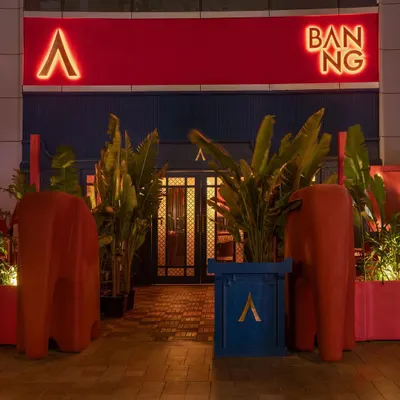 The exterior of BANNG, where bold red branding and sculptural elephant forms create an unmissable statement. This entrance is a portal from the corporate world of Gurugram into a fantastical Thai-inspired narrative.