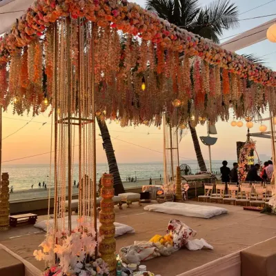 A sunset ceremony with a mandap that feels like a dream. We used cascading floral arrangements and delicate string lights to create this magical setting right on the beach, perfect for a golden hour wedding.