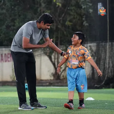More than just a coach. A moment of connection and encouragement between a coach and a young player, capturing the supportive and positive environment we cultivate at our academy.
