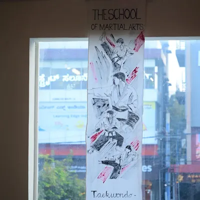 A handmade banner illustrating Taekwondo techniques, created by a student's family for our Black Belt ceremony. This personal touch highlights the deep involvement and support we receive from our community.