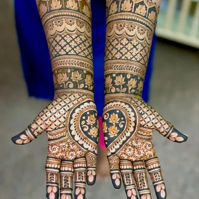 A gorgeous engagement mehendi for Supriya, featuring a heart-shaped design on the palms filled with lotus motifs.