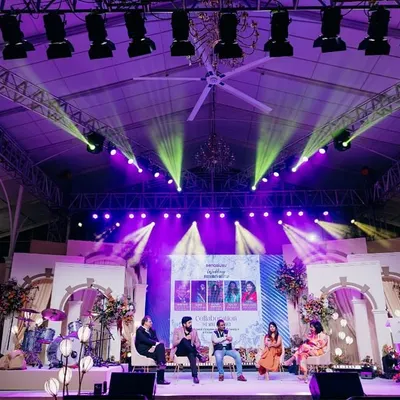 The main stage for the Bangalore Wedding Fraternity meetup. The design incorporated architectural elements and dramatic lighting to create a professional and engaging setting for panel discussions.