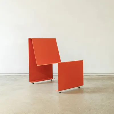 This is the result of our search for the simplest mass-producible chair. Made from bent, drilled, and painted plate metal, its form is a direct expression of its manufacturing process, embodying a quiet and subtle sophistication.