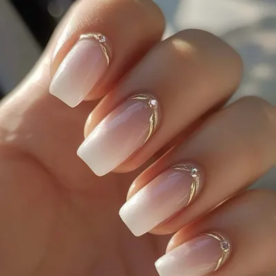 A beautiful example of a reverse French manicure with a soft ombre effect, accented with a delicate silver line and a single rhinestone for a touch of elegance.