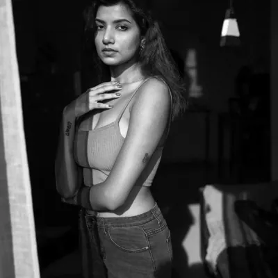 This black and white portrait was shot indoors at 9 AM using only natural light from a window. I intentionally used the curtains to cast interesting shadows on the model, adding depth and mood to the shot.