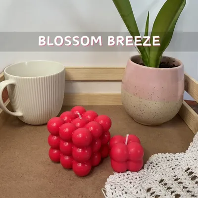 Meet our Bubble Candle in the fresh 'Blossom Breeze' scent. The vibrant red color and floral fragrance make it a lively addition to your home decor, shown here in both our regular and mini sizes.