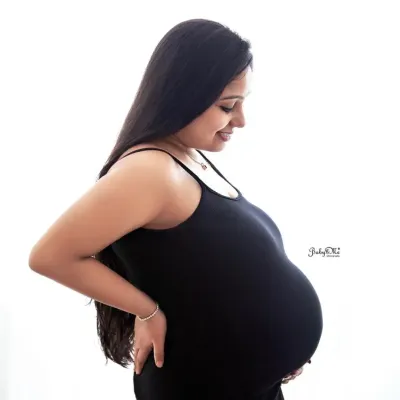 A simple, classic silhouette shot. This side profile against a clean white background is a beautiful way to capture the perfect shape of a baby bump.