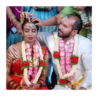 A key moment in a South Indian wedding ceremony. We focus on capturing the significant rituals with reverence and an eye for emotional detail, like this traditional blessing.