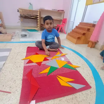 These are the Constructive Triangles. By combining different triangles, this child is discovering how they can form other shapes like squares and rectangles. It's a hands-on, problem-solving approach to learning geometry.