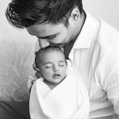 This is the kind of moment I live to capture. The pure, quiet love of a father holding his newborn for the first time, preserved forever in a timeless black and white portrait.