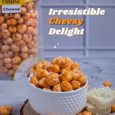 If you love cheese, you will love this. My Cheesy Makhana is the perfect guilt-free snack for your late-night cravings. This shot shows a full bowl of cheese-flavored fox nuts, with the packet and fresh cheese in the background.