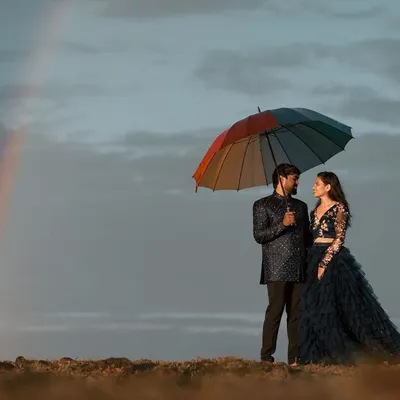 This coordinated couple's outfit is perfect for a dramatic pre-wedding photoshoot. The dark, elegant gown and matching men's suit create a powerful, romantic look against any backdrop.