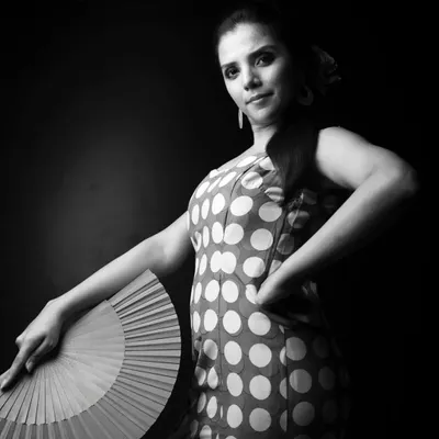 To dance is a divine feeling, especially when you can inspire the next generation. This portrait captures the passion I feel for the art form, a feeling I aim to plant as a seed in young minds. Using props like the 'abanico' or fan, I share the history and grace of Flamenco with authenticity.