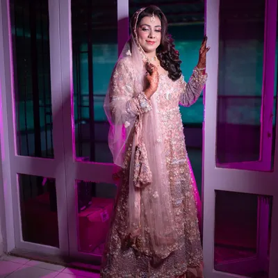 A beautiful full-length shot of my Walima bride. The soft pink, heavily embellished gown is paired with elegant makeup and side-swept curls for a glamorous reception look.