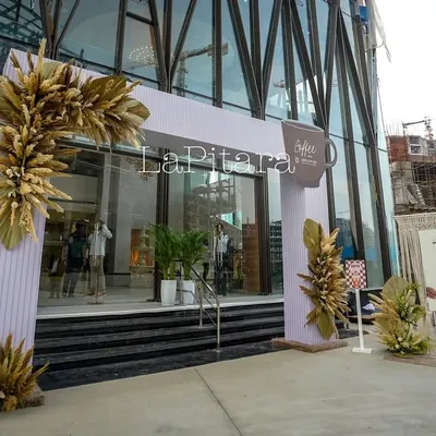 The grand entrance to our "Coffee Fest" for Group 108. We designed this modern arch with rustic pampas grass arrangements to establish the event's aesthetic and welcome guests into the themed experience.