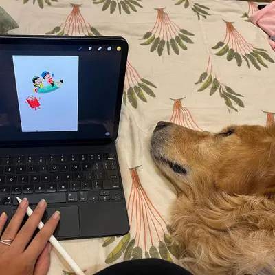 This is my typical workspace: me on my bed, sketching on my tablet, with my dog and chief creative officer right by my side. My process is all about comfort and creativity.