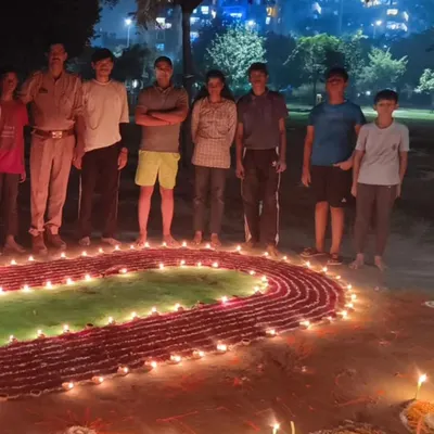 Our whole group celebrating Diwali. We created this special rangoli of a running track and a long jumper to show our shared passion for athletics.