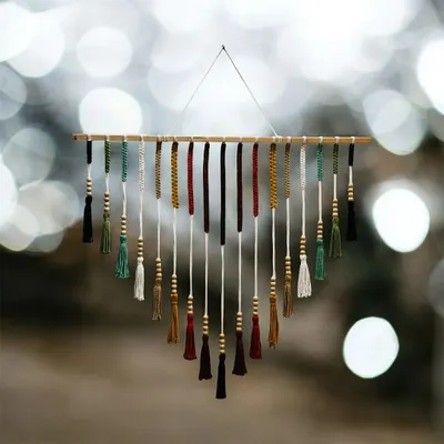This is one of my favorite wall hangings, and it truly captures the bohemian spirit of my craft. The rich, earthy tones and delicate wooden beads create a stunning V-shape tassel design that brings warmth and texture to any wall. It’s a perfect statement piece for a living room or bedroom.